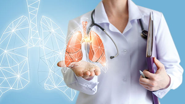 Graphical picture of a doctor holding an illustration of a set of lungs.