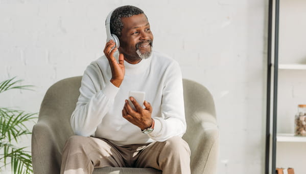 man with headphones sitting in chair man with headphones sitting in chair