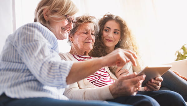 three women sitting on the couch together
