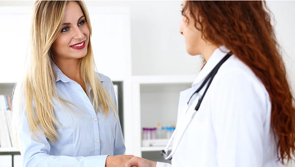 A woman is talking with her doctor.