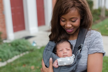 African American mother with baby in carrier