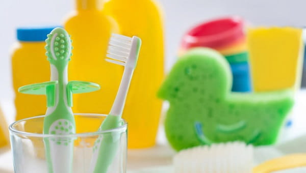 Closeup of babys first toothbrushes in the bathroom