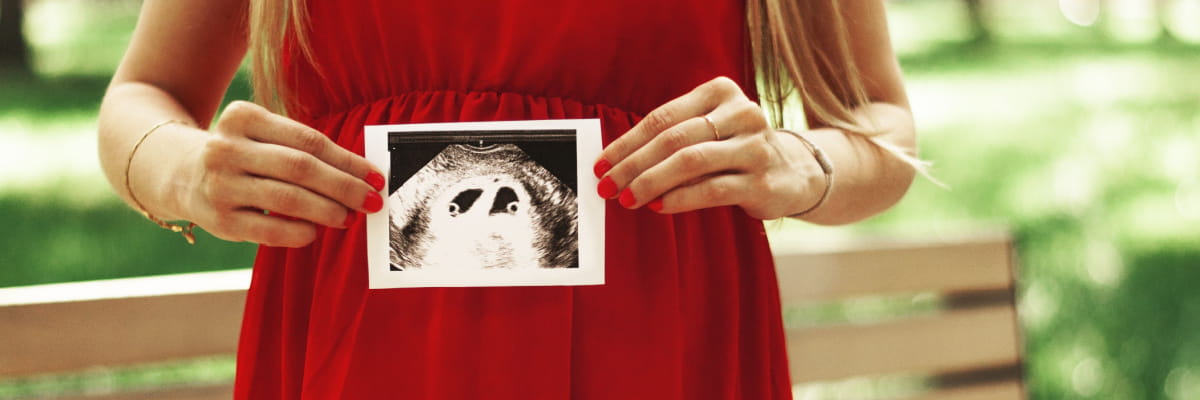 First Trimester Wellness Resources at BayCare Pregnant woman holds in her hands an ultrasound scan of twins in the first trimester.